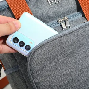 Gray insulated lunch bag with orange straps showing front pocket capacity for daily use.