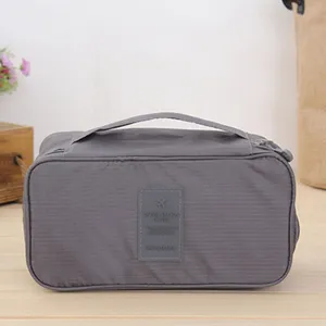 Gray portable travel organizer bag, multi-functional makeup and toiletry storage pouch.