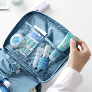 Blue travel cosmetic bag portable waterproof toiletry organizer with mesh compartments for trip.