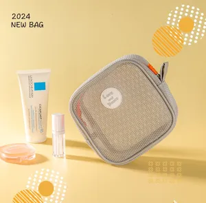 Detail view of portable grey mesh cosmetic bag with zipper, ideal for travel and makeup storage.