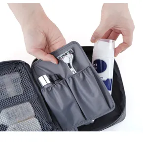 Dark gray travel toiletry bag, portable cosmetic organizer pouch with multiple mesh compartments.