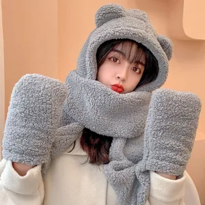 Detail shot of cute grey plush bear ear hooded scarf and gloves set for winter warmth.
