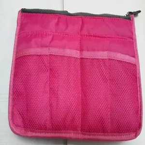 Pink bag organizer insert with mesh pockets and secure top zipper for daily storage use.