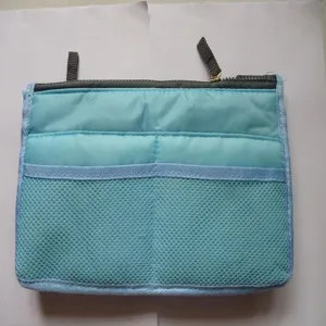 Detail view of the multi-functional organizer bag insert with zipper and mesh pockets.