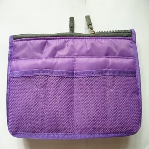 Detail view of purple organizer insert bag, showing mesh pockets and dual zippers.