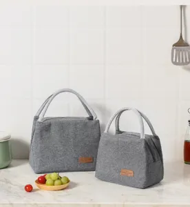 Grey Oxford cloth insulated lunch bag detail shot with practical handles and neat stitching.