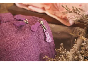 Close-up detail of durable purple travel storage bag zipper pull with texture fabric.
