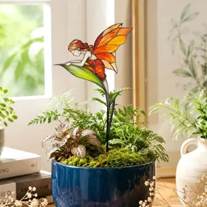 Detailed close-up view of stained glass fairy plant stake showcasing garden potted decor.