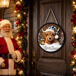 Round Christmas hanging sign featuring a cute highland cow with a plaid hat and festive lights.