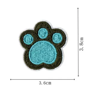 Bear paw embroidery patch detail view, blue and green cute animal badge for clothing and DIY decor.