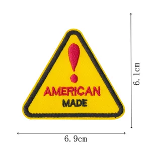 Close-up detail of the yellow warning sign embroidered patch with American made text.