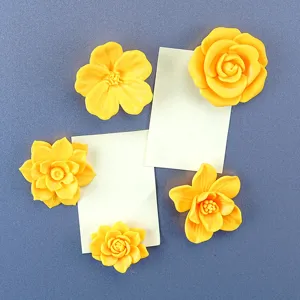 Detailed close-up of creative 3D printed yellow floral refrigerator magnets showing unique texture.