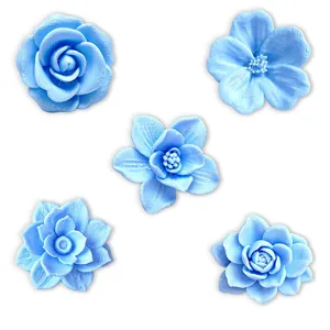 Close-up detail of light blue 3D printed flower fridge magnets, featuring intricate floral textures.