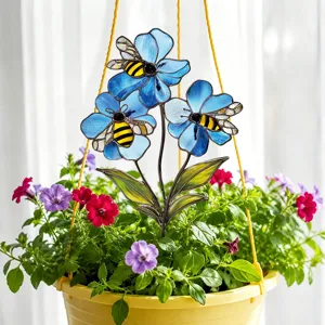 Garden stake detail showing blue stained glass flowers and bees in a hanging pot scene.