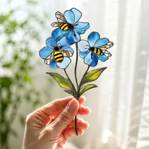 Stained glass blue flowers with cute bees metal art insert, perfect for garden and home decor.