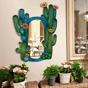 Detail view of the bohemian cactus wall mirror, featuring colorful painted floral design.