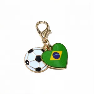Gold tone alloy lobster clasp keychain charm featuring football and Brazil flag heart pendants.