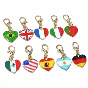 Close-up view of heart-shaped national flag charms with gold lobster clasps for DIY jewelry.