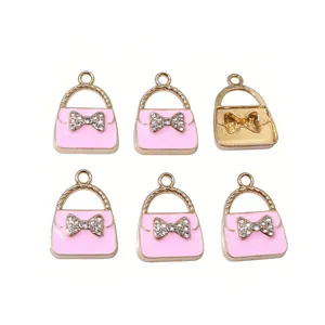 Cute pink alloy handbag pendant charm with sparkling rhinestones, ideal for DIY jewelry making.