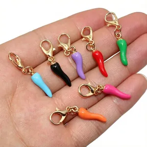 Detailed view of colorful alloy chili pepper charms with lobster clasps for DIY jewelry.