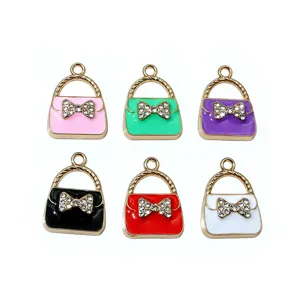 Enamel alloy handbag charms with crystal bow design, gold tone metal jewelry making accessories.