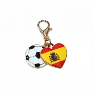 Close-up detail of the alloy lobster clasp keychain with soccer and Spanish flag heart charms.