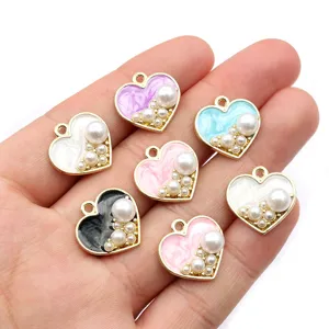 Enamel alloy faux pearl heart charm detail shot, perfect for DIY jewelry making and earrings.