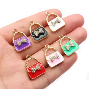 Enamel alloy mini handbag charms with rhinestones and bow, perfect for DIY jewelry making.