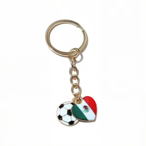 Metal keychain detail featuring a soccer ball and heart Mexico flag drip oil charm pendant.