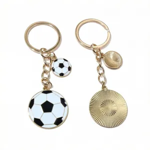 Gold metal keychains with enamel football and sunburst disc pendants, bag charms.