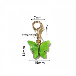 Green glitter acrylic butterfly pendant with gold lobster clasp DIY jewelry accessory detail.
