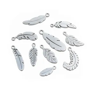 Close-up of assorted stainless steel feather charms, detailed metal DIY jewelry accessories.