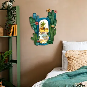 Close-up detail of the boho cactus shaped wall mirror hanging in a cozy bedroom decor setting.