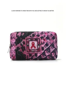Detailed view of a stylish pink quilted makeup bag featuring a classic awareness ribbon motif.
