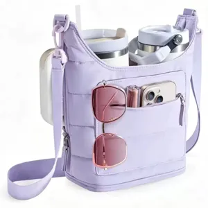 Detail view of quilted crossbody bag with dual cup holders, phone and sunglasses compartments.