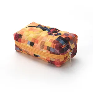Quilted cosmetic bag with cute puppy print, orange patchwork design, large capacity storage.