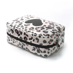 Waterproof leopard print cosmetic bag with heart pattern for travel and daily storage.