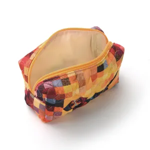 Quilted cosmetic bag with cute dog print and patch design, orange zip makeup pouch for women.
