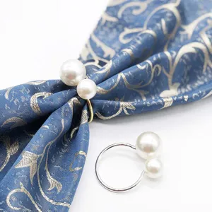 Pearl napkin ring detail showing double faux pearls and metal loop design for table decor