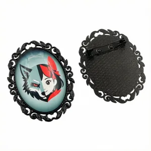 Detailed view of oval vintage alloy brooch pendant bezel with glass cabochon, front and back.