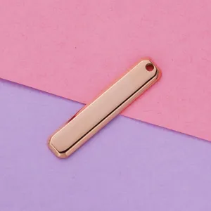 Closeup of rose gold polished stainless steel rectangular blank pendant DIY jewelry accessory