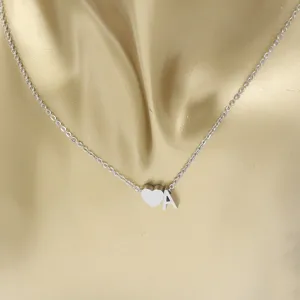 Detailed view of silver stainless steel necklace featuring a heart and letter A pendant.