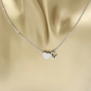 Stainless steel heart and letter C pendant necklace, stylish jewelry accessory for women.