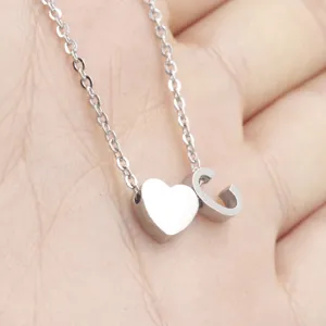 Close-up detail view of the stainless steel heart and letter C necklace pendant.