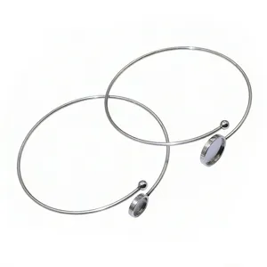 Close-up detail of stainless steel DIY blank bezel bangles with round tray and ball ends.