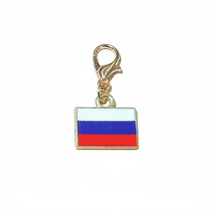 Close-up of Russia flag metal pendant, gold lobster clasp DIY jewelry accessory charm detail.