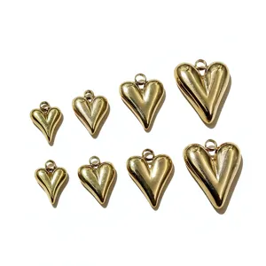Close-up detail of 3D puffy heart gold metal pendants charms for jewelry making DIY accessories.