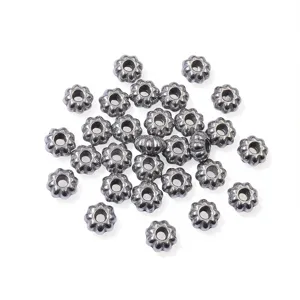 Detailed close-up view of grey metallic pumpkin spacer beads for DIY handmade jewelry crafting.