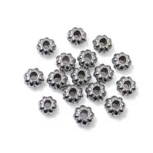 Detailed close-up view of metallic pumpkin flower spacer beads, perfect for DIY jewelry crafting.