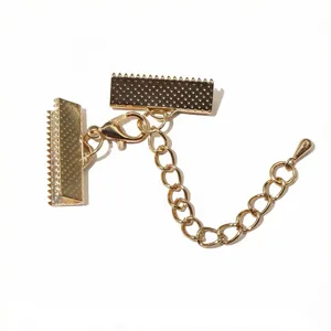 Gold DIY jewelry accessory detail showing lobster clasp, extension chain, and cord clamps.